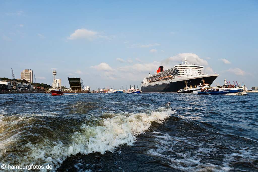 bz0444 Das Kreuzfahrtschiff "Queen Mary 2" laeuft aus dem Hamburger Hafen aus, zahlreiche kleine Schiffe begleiten den Luxusliner, sonnig